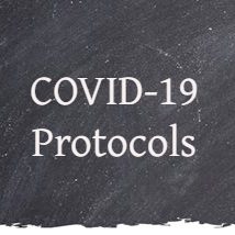 Chalkboard with writing "COVID-19 Protocols"